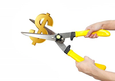 Tips to Cut Spending to Save More Cash Hands With Scissors Cutting Us Dollar by Natara and freedigitalphotos